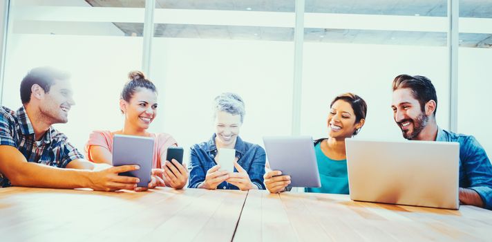 Young creative business people with laptop and digital tablet in the office