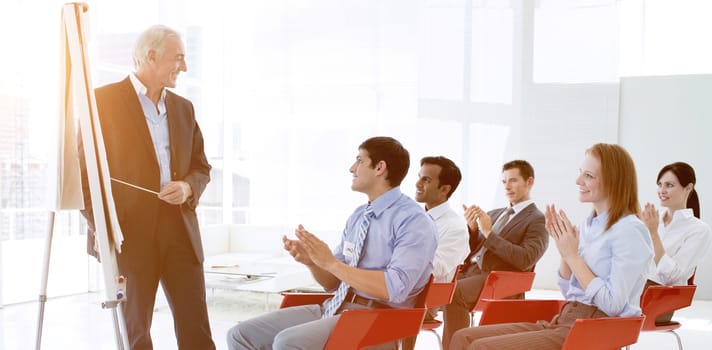 Business people applauding at the end of a conference in the office