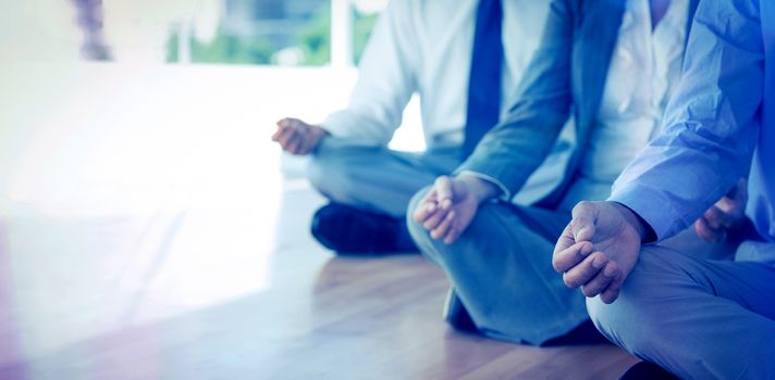 Close up view of business people doing yoga in office 