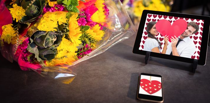 Cute heart decoration against technology with fresh colorful bouquet