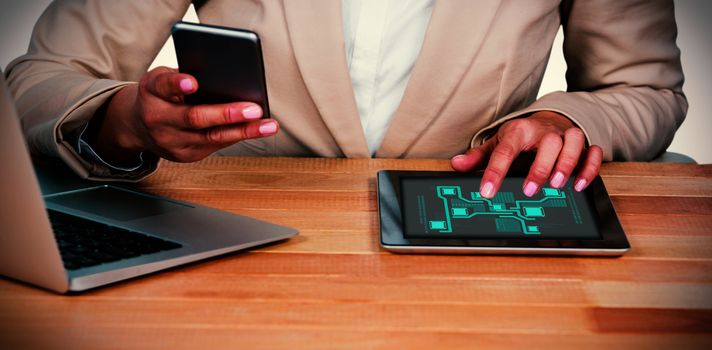 Technology interface  against midsection of businesswoman using mobile phone and digital tablet with laptop on table