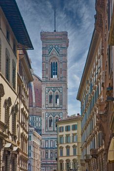 The bell tower of the Il Duomo church in Florence, Italy from a narrow street
