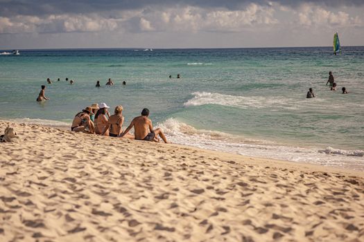 DOMINICUS, DOMINICAN REPUBLIC 6 FEBRAURY 2020: People sitting on the seashore look at the sea