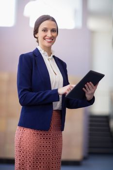 Portrait of a businesswoman holding digital tablet at conference centre