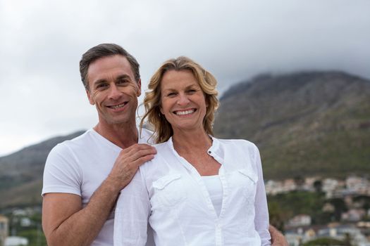 Romantic mature couple standing together on the beach
