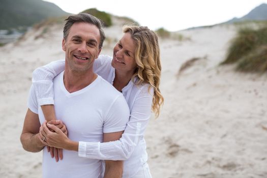 Romantic mature couple standing together on the beach