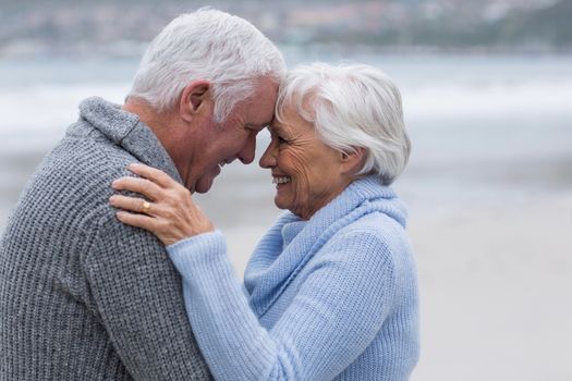 Romantic senior couple standing together on the beach