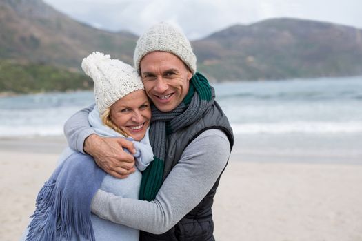 Romantic mature couple embracing each other on the beach