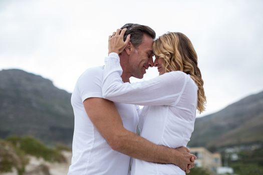 Romantic mature couple embracing each other on the beach