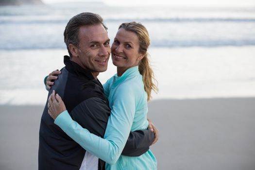 Romantic mature couple embracing each other on the beach