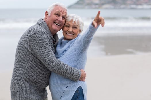 Romantic senior couple standing together on the beach