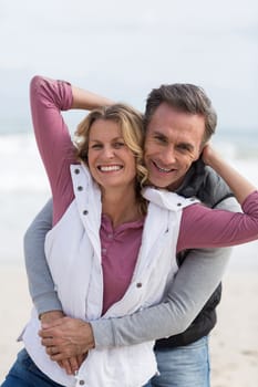 Portrait of mature couple enjoying on the beach