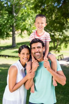 Portrait of family enjoying time together in the park on a sunny day