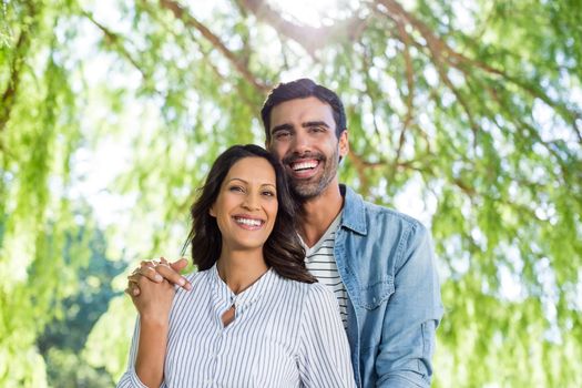 Portrait of romantic couple smiling in park