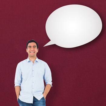 Smiling casual man standing against speech bubble