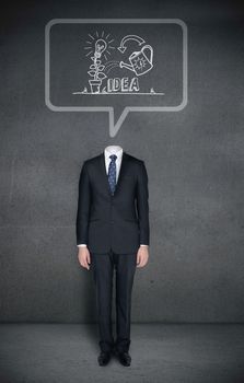 Composite image of headless businessman with idea concept in speech bubble in grey room