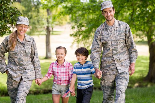 Military couple with their kids in park on a sunny day