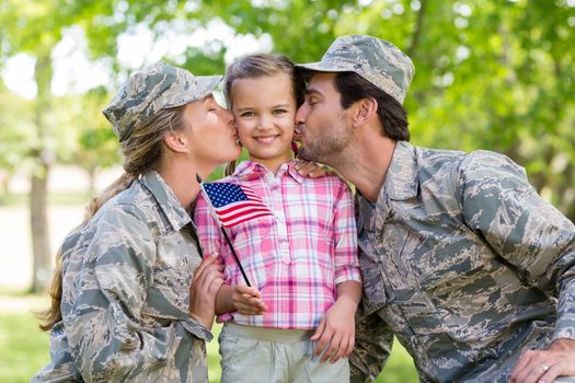 Military couple with their daughter in park on a sunny day