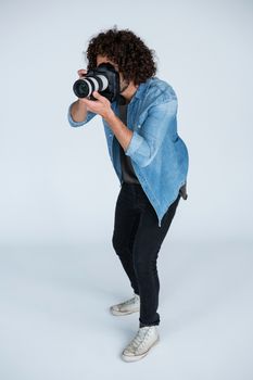 Male photographer with digital camera in studio