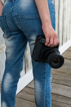 Mid section of female photographer with digital camera