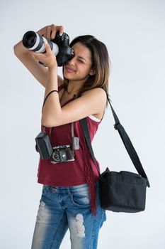 Female photographer with digital camera in studio