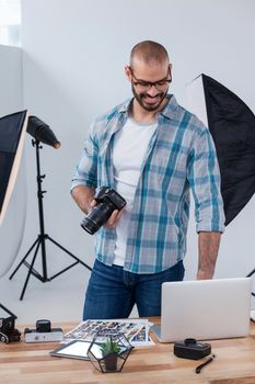 Male photographer working at desk in studio