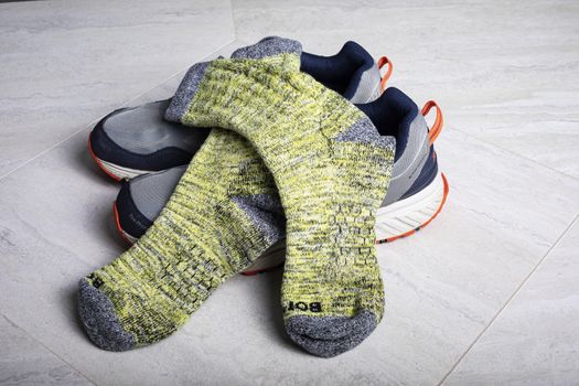 Yellow Bombas calf socks shown with athletic shoes. Honeycomb weave of arch is visible.