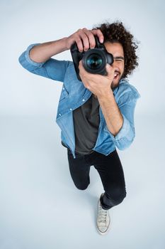 Male photographer with digital camera in studio