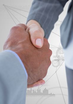 Digital composite image of business professionals shaking hands on technology background