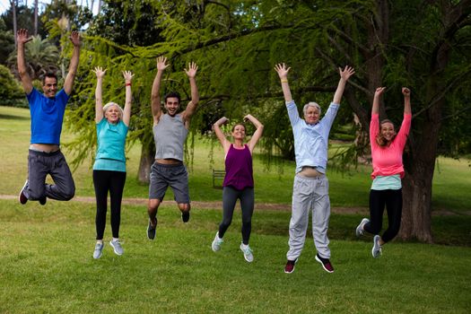 Group of people exercising together in park