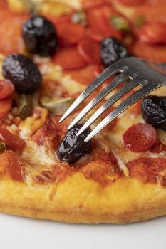 closeup of an fork on italian pizza