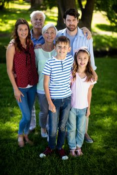 Portrait of happy multi generation family standing in park