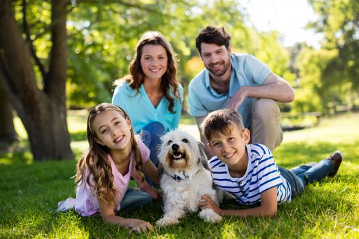 Portrait of happy family enjoying in park on sunny a day