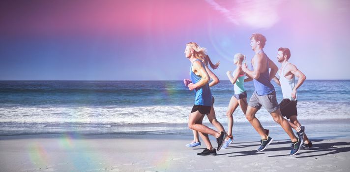 People jogging on beach on sunny day