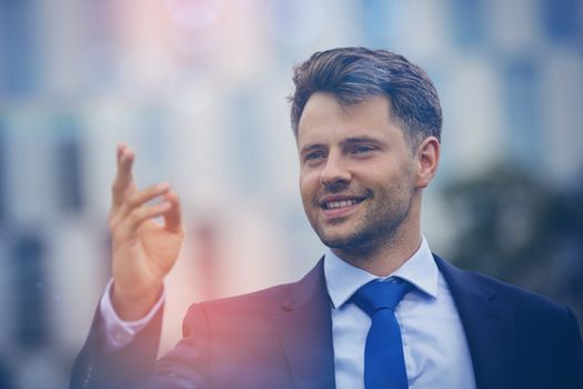 Close up of cheerful businessman gesturing outdoors
