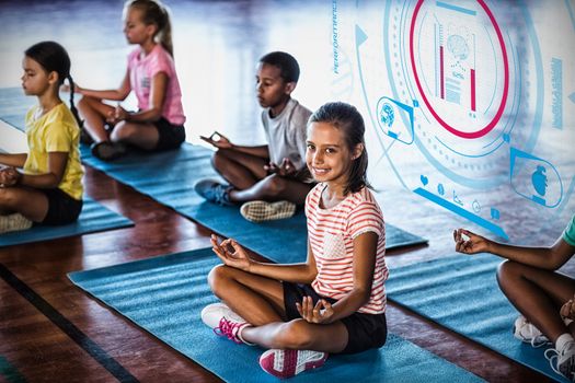 Fitness interface against school kids meditating during yoga class