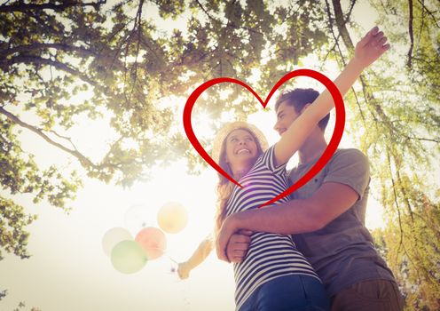 Composite image of romantic couple embracing in park with a drawn red heart shape 