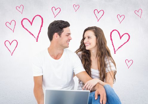 Romantic couple sitting against white background with pink heart shapes
