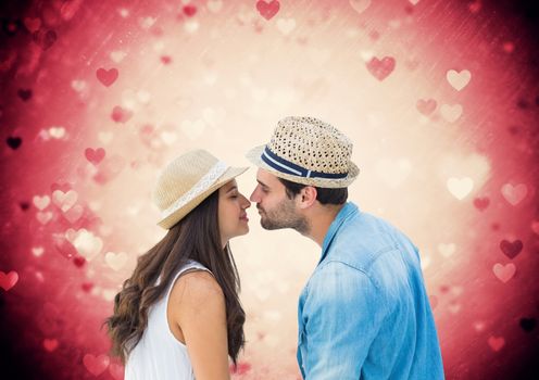 Composite images of romantic couple about to kiss with heart shapes in background
