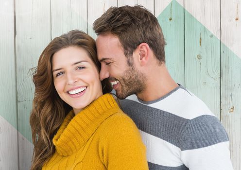 Romantic couple embracing each other against wooden background