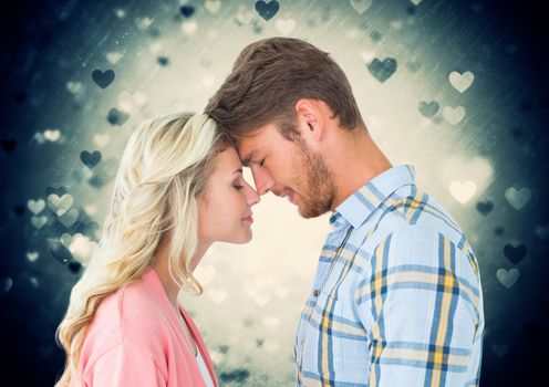 Composite images of romantic couple rubbing nose each other with heart shapes in background