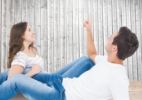 Romantic couple having fun against wooden background