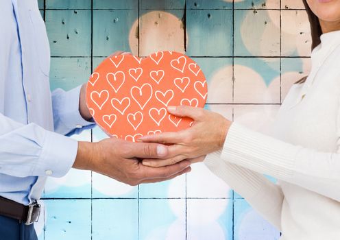 Mid-section of romantic couple holding a gift box