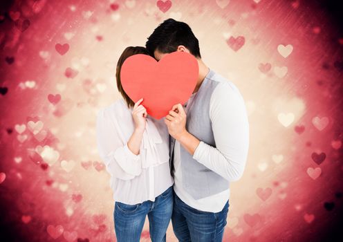 Composite image of romantic couple holding heart shape and kissing each other 