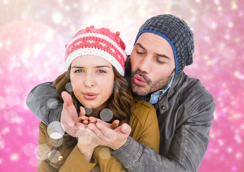 Romantic couple giving flying kiss against digitally generated pink background