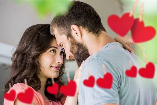 Romantic couple staring at each other with red hanging hearts