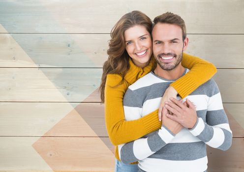 Portrait of romantic couple embracing each other against wooden background