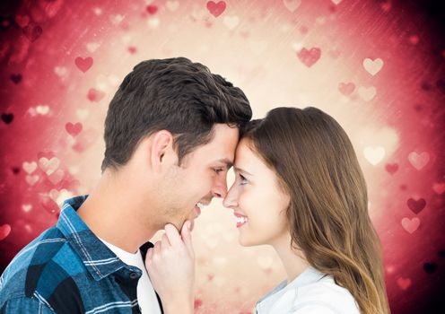 Romantic couple looking at each other against digitally generated background
