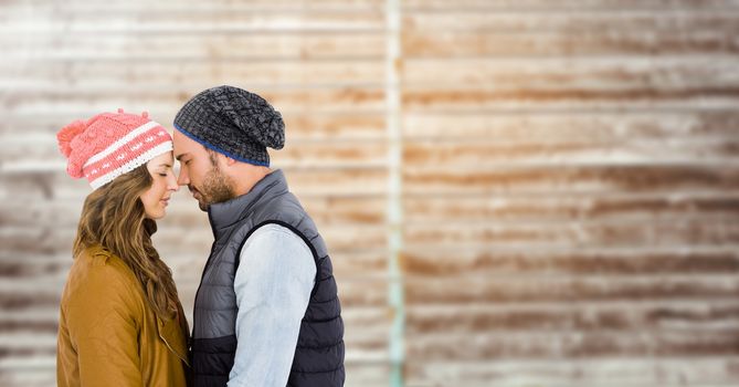 Romantic couple embracing each other against wooden background