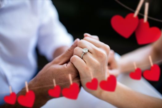Close-up of romantic couple holding hands